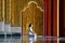 Asian long hair man relaxes meditation with all white costume sit in front of Buddist`s gold wallpaper in the Temple, Thailand