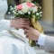 Asian lovers\' hands holding vintage flower