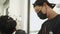 Asian male barber shop, man Getting Hair Cut at the Barbershop wear black protective mask. job opportunity Professional, Barber in