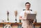 Asian male Barista cafe owner using laptop in cafe business inside coffee shop,looking and smile at camera.food and drink