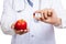 Asian male doctor with apple and capsule
