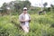 Asian male farmer supervise his ginger plants cultivation. Organic farming