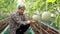 Asian male farmers grow melons in large greenhouses.