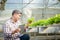 Asian male farmers grow soilless hydroponics lettuce in greenhouses.