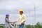 Asian male and female engineers are planning develop wind power