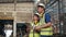 Asian male and female in uniforms and helmets. Both workers are in industrial factories. Using tablet to inspect goods and product