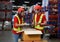 Asian male and female workers in safety suits wear hard hats. pack the product into a box