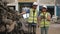 Asian male and female workers in uniforms and helmets, Employee stock check of car spare parts warehouse factory. Using a tablet t