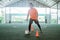 Asian male futsal players practice dribbling over horn obstacles