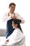 Asian male hairdresser make hairstyles for Asian female customers in modern beauty salons.