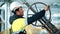 Asian male metalworker in helmet rotation wheel rig mechanic gear detail at industrial production