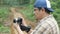 Asian male photographer or videographer holding camera and shooting natural wildlife, safari trip in the wild, nature journey