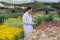 Asian male researchers and chrysanthemum data recording in garden