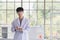 Asian male scientist stand and smile in lab room