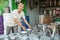 Asian male smiling while arranging the many buckets