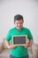 Asian male smiling to camera holding blank chalk board