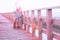 Asian man with camera and bag standing on wooden bridge seeing around beach and sand, Summer travel