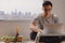 Asian man in casual wear sitting and working on laptop in room