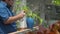 Asian man cleaning dust from green plant leaf by cloth at river front home. plant care concept.