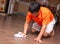 Asian man cleaning floor
