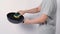 Asian man cleaning the pan with dishwashing sponge and white background