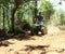 Asian Man Driving All-Terrain Vehicle on Jungle