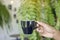 Asian man hand holding black cup of hot coffee with steaming