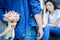 Asian man has preparing and waiting with flower for say sorry an