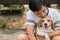 Asian man lovely cute playing with his puppy animal pet , Beagle are friendly dog with human