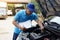 Asian man mechanic checking and analyzing car engine