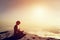 Asian man meditates in yoga position. Above clouds