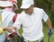 Asian man picking ball from his caddie when playing golf in course