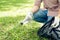 Asian man picking up plastic household waste in park