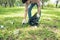 Asian man picking up plastic household waste in park.