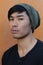 Asian man with piercing and beanie