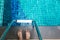 Asian man`s feet at the edge of the pool. He is going to swim