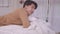 Asian man sleeping well in a comfy warm fresh bed on a soft pillow white linen orthopedic mattress, a calm serene male relaxing