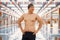 Asian man standing in indoors swimming pool and wearing a hat