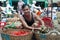 Asian man street market seller bunch green onion