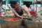 Asian man street market seller bunch green onion