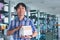 Asian man student hold books in a library