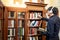 Asian man student picking vintage book in library