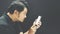 Asian man stunned using smartphone in dark style