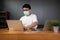 Asian man it support working with computer laptop to remote desktop and wearing protective medical mask for prevent virus Covid-19