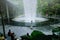 Asian man taking photo of Rain Vortex fountain at Changi Airport Jewel