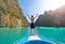 An Asian man, a tourist, standing on a boat to snorkeling or diving in Krabi with blue turquoise seawater, Phuket island in summer