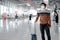 Asian man tourist wearing mask in airport terminal