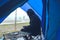 Asian man travel relax in the holiday. camping on the Mountain. sit relax on the chair. In the atmosphere rain fall have fog down