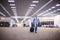 Asian man traveler with suitcases walking and transportation at an airport