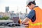 Asian man using drone and laptop for construction site survey